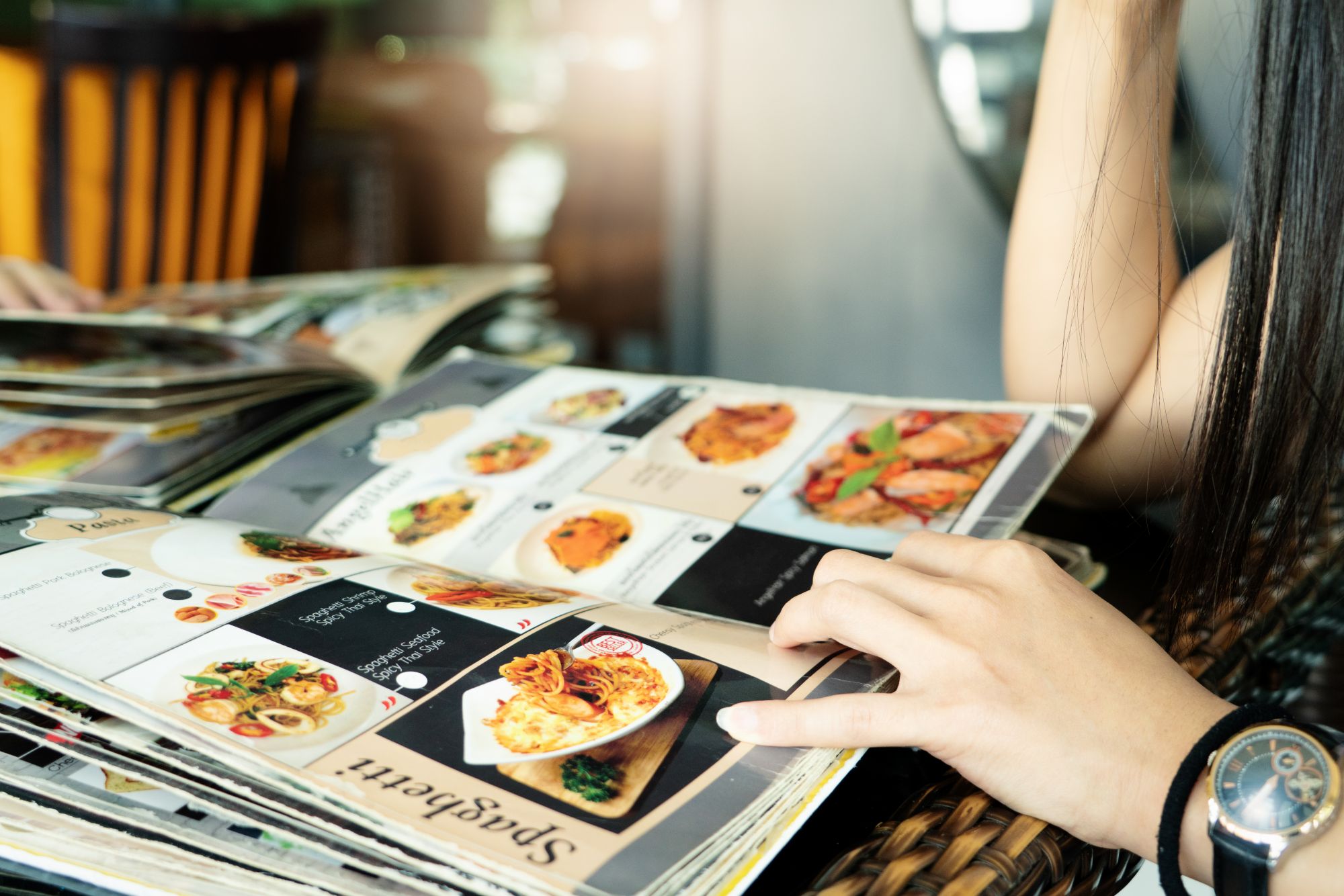 young women looking menu at restaurant, selective focus on menu