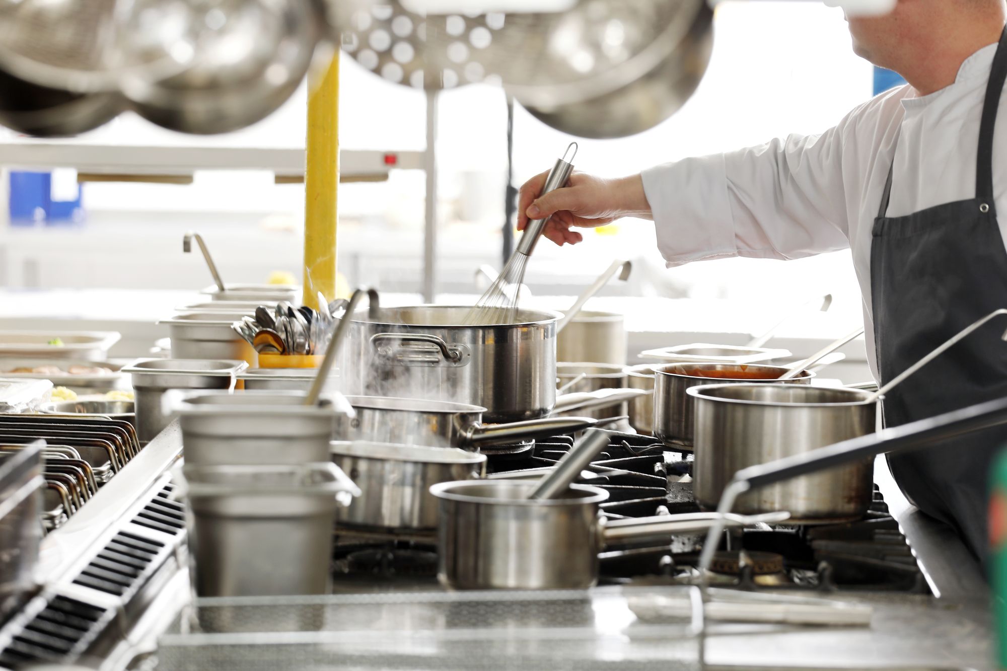 BOG - Chef cooking, commercial range with pots and pans