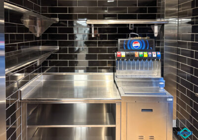 Drive-Up Pickup Area: Soda Machine with Ice Bin Base, Beverage Counter, Wall Shelving System