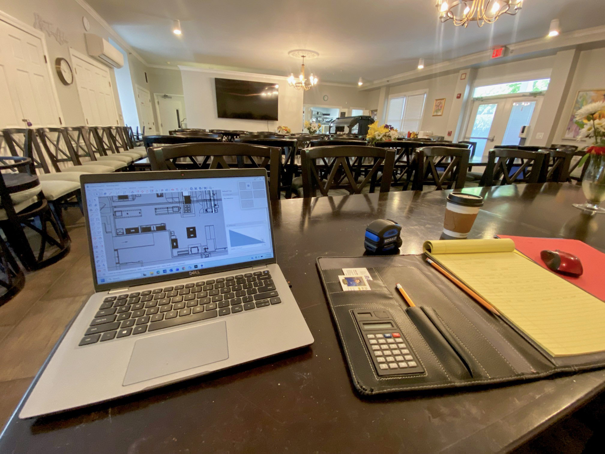 Solutions engineer documenting kitchen programming notes during site visit